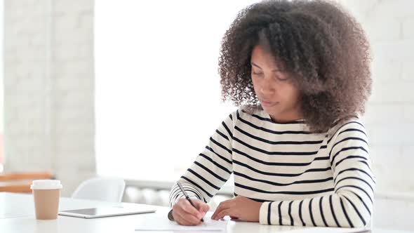 African Woman Writing on Paper, Stock Footage | VideoHive