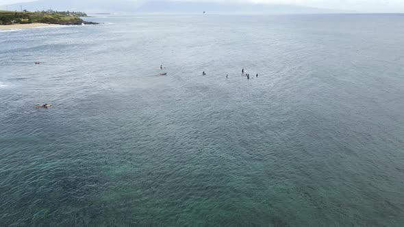 Surfers in the Lineup waiting for Waves on Maui Hawaii Island in Pacific Ocean, Aerial alt