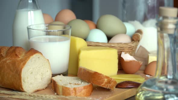 Table with Rustic Products Milk Bread Eggs Butter Cheese Olive Oil alt