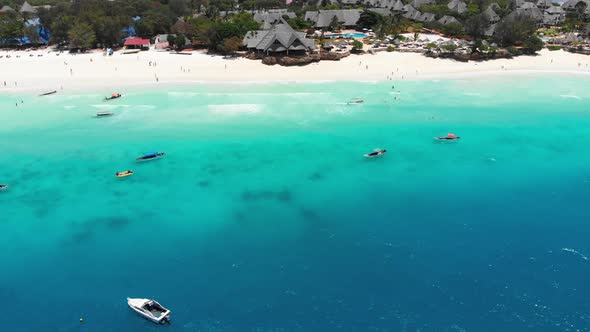 Exotic Sandy Beach with Turquoise Ocean Boats and Hotels Zanzibar Aerial View alt