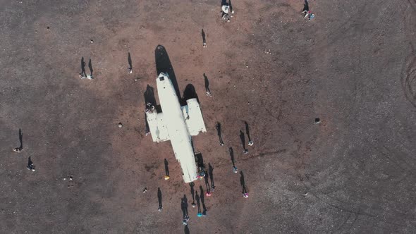 Travelers gathering around crashed airplane alt