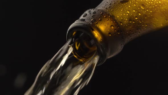 Beer Pouring Into Glass From Brown Bottle