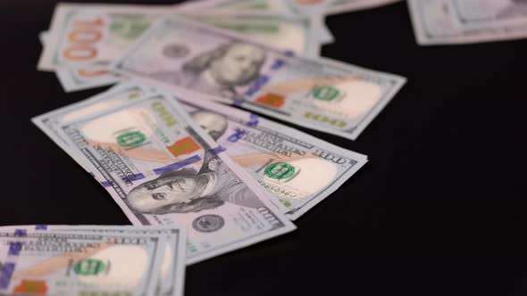 Close up view of dollar's banknotes falling on black background. Economy cash money concept. Sweden. alt