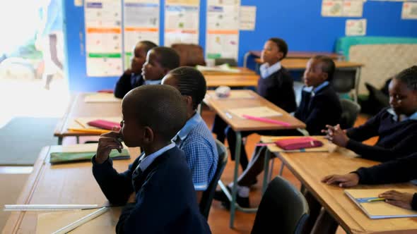 Schoolkids studying in the classroom 4k alt