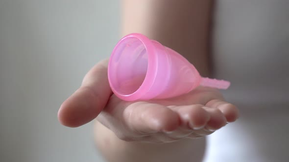 Young Woman Hand Holding Reusable Silicone Menstrual Cup