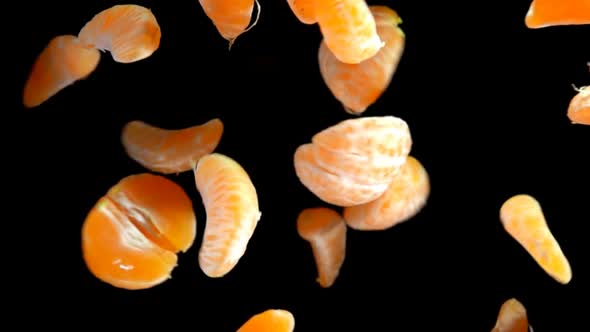 Peelled Pieces of Tangerine Are Flying and Spinning alt