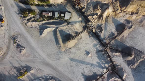 Aerial view of the limestone quarry with machinery and conveyor.