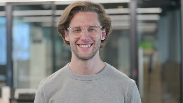Portrait of Young Businessman Shaking Head As Yes Sign alt