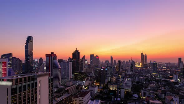 Bangkok business district city center above Silom area, day to night, zoom out – Time Lapse