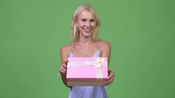 Young Happy Beautiful Businesswoman Giving Gift Box