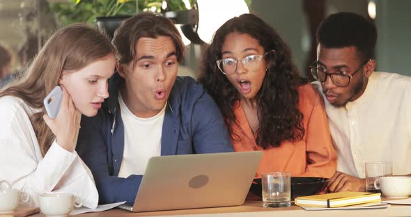 Crop View of Millennial Coworkers Making Amazed Face While Looking at Laptop Screen. Young Surprised