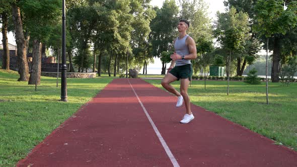 Sportsman Guy Jogging in Place with a High Rise of the Shin Warming Up alt