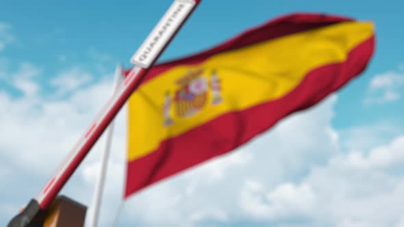 Barrier Gate with QUARANTINE Sign Closing with Flag of Spain As Background alt