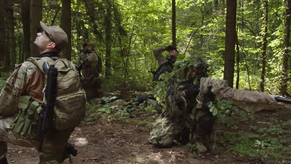 Soldiers Giving Hand Signals to Evacuation Transport Using Radio Call alt
