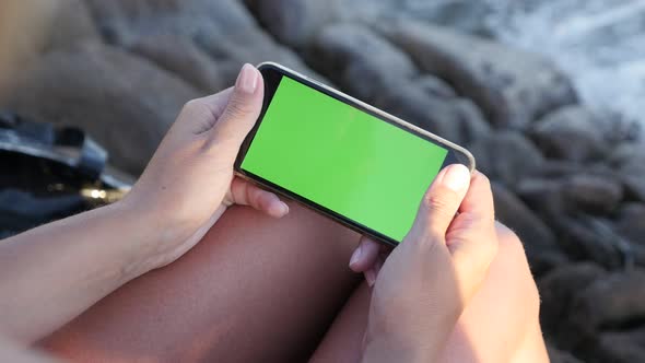 Woman with chroma key display gadget in hands 3840X2160 UHD video - Close-up  female on the beach ho