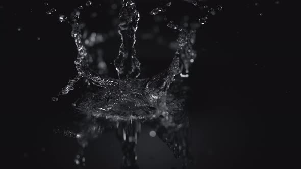4K 30fps, Pouring water into puddle, Slow Motion alt
