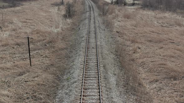 Descending on railroad by the day 4K aerial video alt