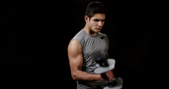 Young Man Working on Triceps With Dumbbells 15B
