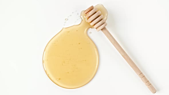 Rotation of the Composition with Fresh Honey on a White Background Top View alt