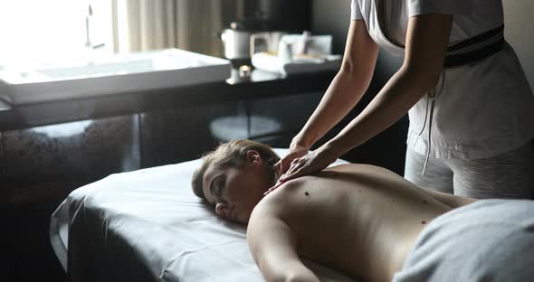 Young Woman Relaxing with Massage at Beauty Spa
