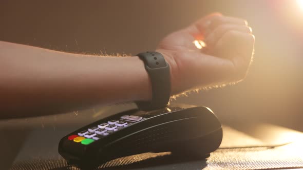 Person Pays in a Cafe Using an Electronic Smartwatch Contactless Technology NFC