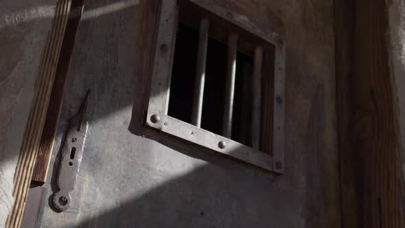 Old west jail door tilt down from window to lock alt