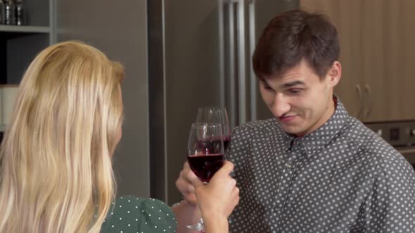 Handsome Man Clinking Glasses with His Girlfriend Celebrating Buying New Home alt