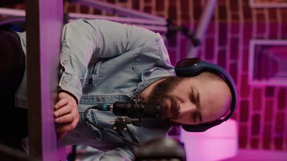 Selective Focus on Male Content Creator Streaming Live Internet Vlog Using Digital Video Camera alt