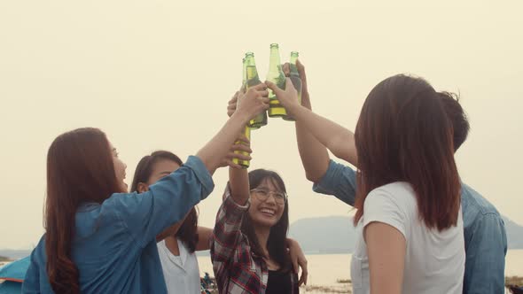 Group of Asia best friends teenagers salute and cheers toast of bottle  beer enjoy party with happy. alt