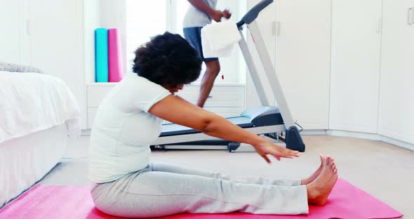 Woman exercising while man jogging on treadmill 4k alt
