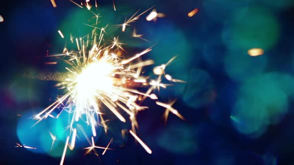Burning Sparklers Are Lit Against a Bright Background