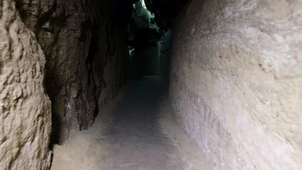 Speleology, cave, dungeon, dark tunnel, underground excavations. The old cave is formed by water alt