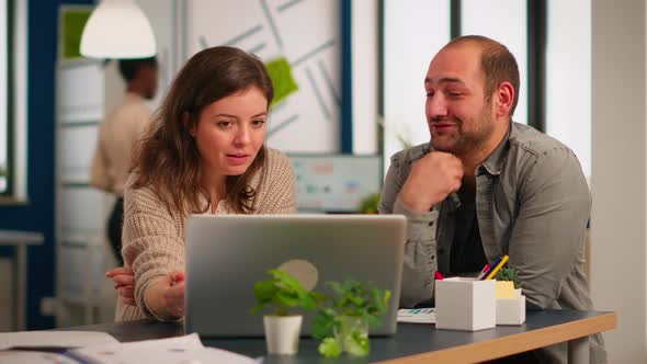 Woman Manager Pointing on Laptop Showing New Startup Idea To Coworkers alt