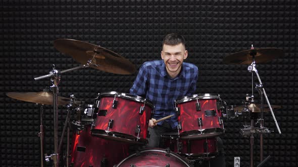 Drummer is performing drum solo on cymbals. Smiling drummer  alt
