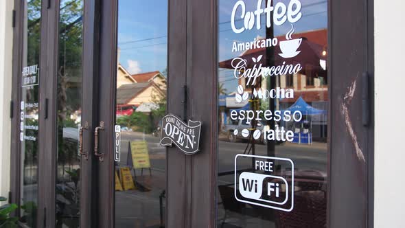 Open Sign In Front Of Coffee Shop alt