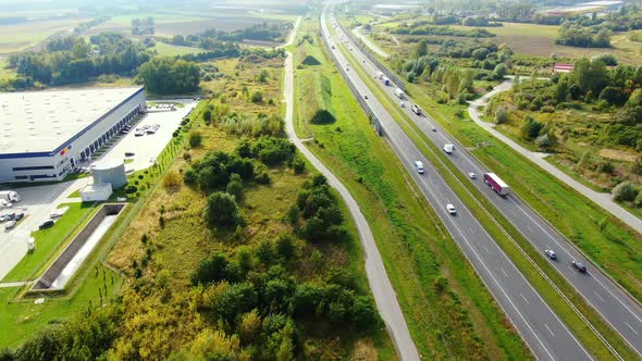 Aerial view of modern storage warehouse. Logistics center in industrial city zone from drone view. B alt