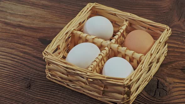 Hen's eggs in a woven straw basket. Happy Easter.