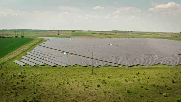 Aerial Drone View. Solar Power Plant Farm in Summer. Production of Clean Energy. Wide View alt