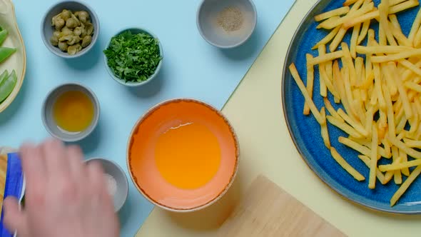 Vertical Flat Lay Video Chef Cooks Sauce for the French Fries