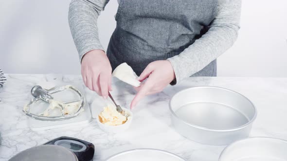 Step by step. Greasing cake pans with butter to bake funfetti cake alt