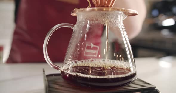 Process of V60 Barista at Work Make a Coffee in a Transparent Glass Bowl alt
