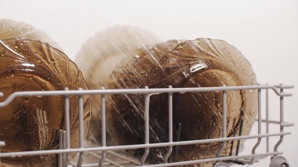 Plates in Dishwasher Machine Under Spraying Stream of Water alt