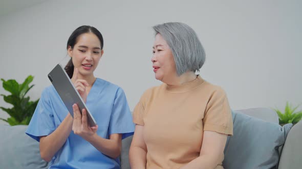 Asian nurse showing health checkup report to grandmother and giving advice