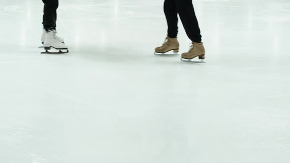 Close Up View of Figure Skater's Skating Shoes on Ice Rink