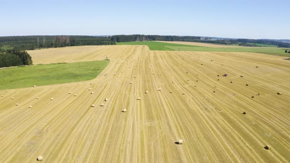 Aerial Drone Shot  a Field with Hay Bales in a Rural Area on a Sunny Day alt