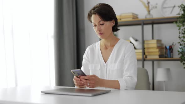 Woman Reading Message on Smartphone