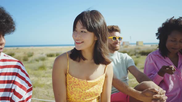 Group of friends having fun on the beach. alt