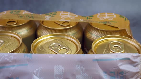 Aluminum beer cans. Tin cans in plastic wrap.