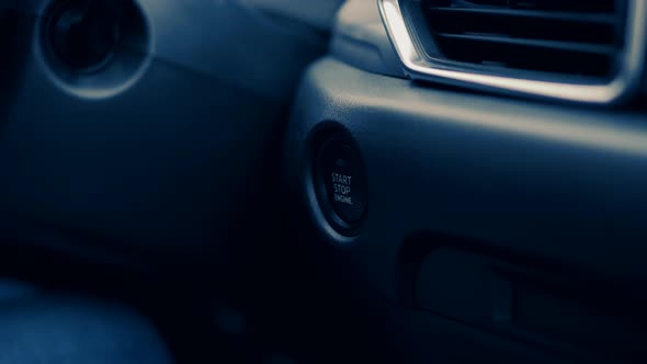 Starting Car Engine In Hybrid Auto. Finger Pushing Power Ignition Button On Keyless Automobile. alt