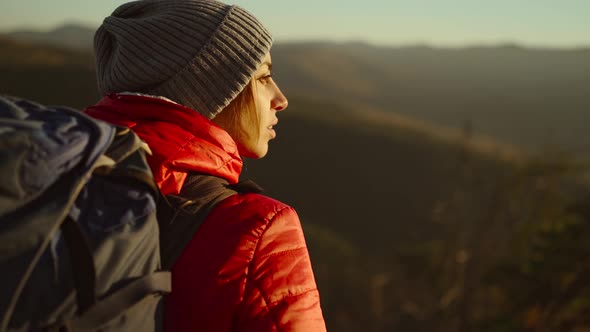Young Woman Enjoying Sunlit Fall Mountain View From the Top alt